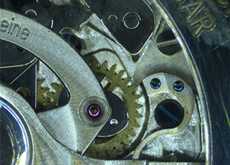 Clock gears under microscope Clock gears under microscope